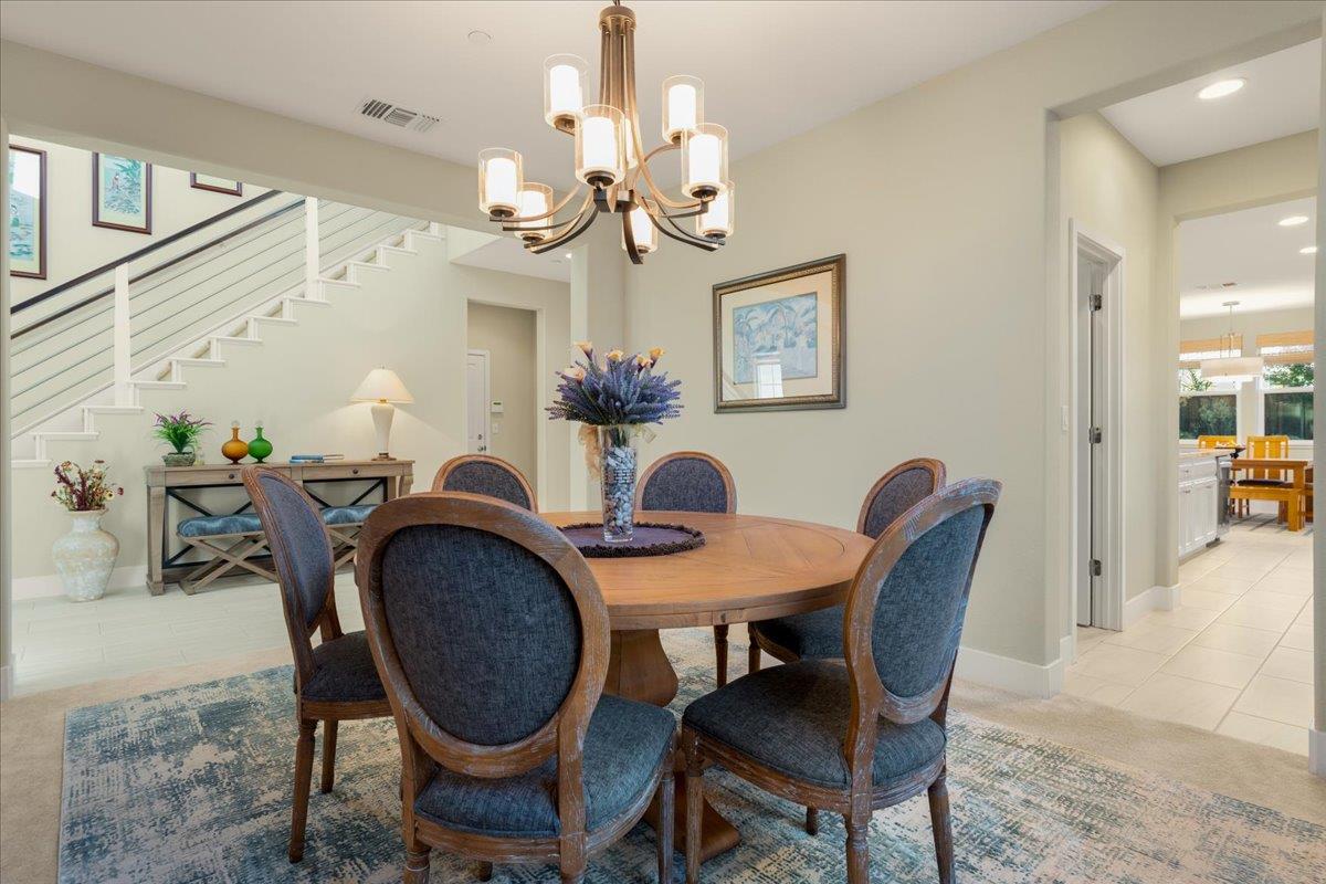 925 Lynx Place Gilroy, CA 95020 - Photo 10 of 49 a view of a dining room with furniture and a chandelier