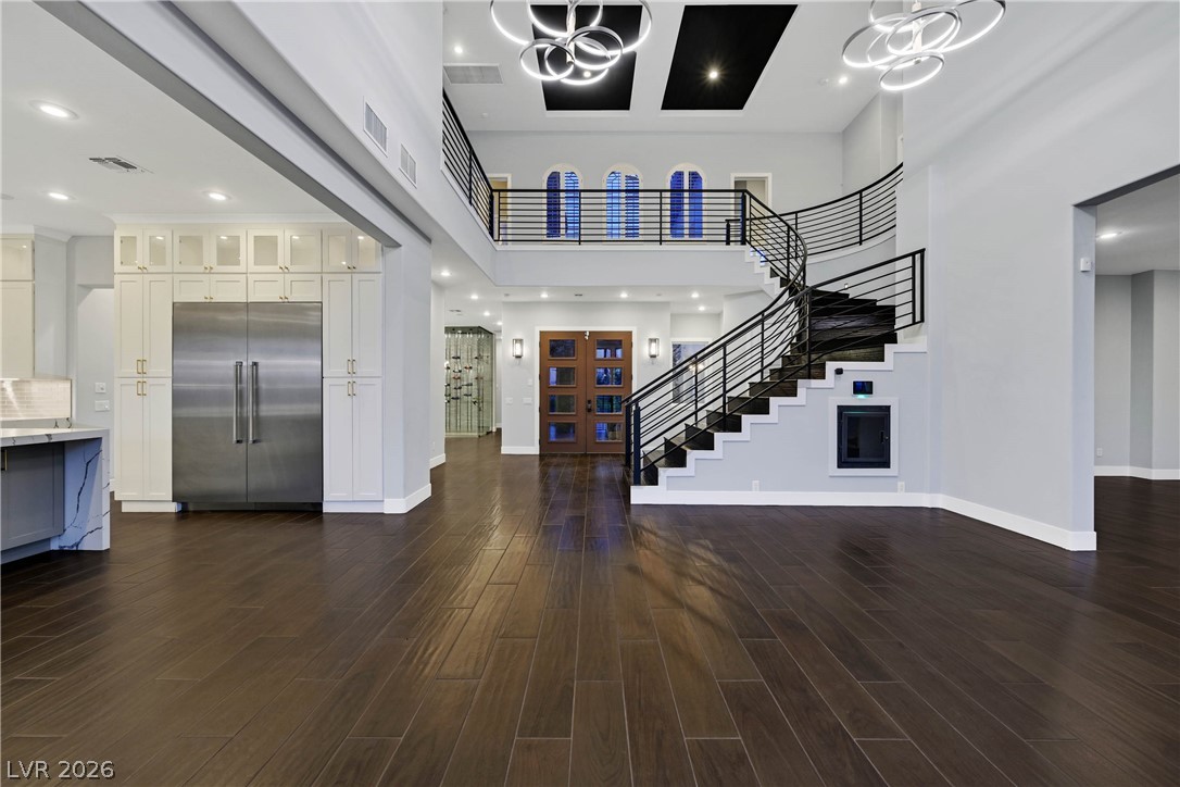 6 Rue Du Ville Henderson, NV 89011 - Photo 30 of 99 This grand foyer welcomes with a striking staircase and rich wood flooring.