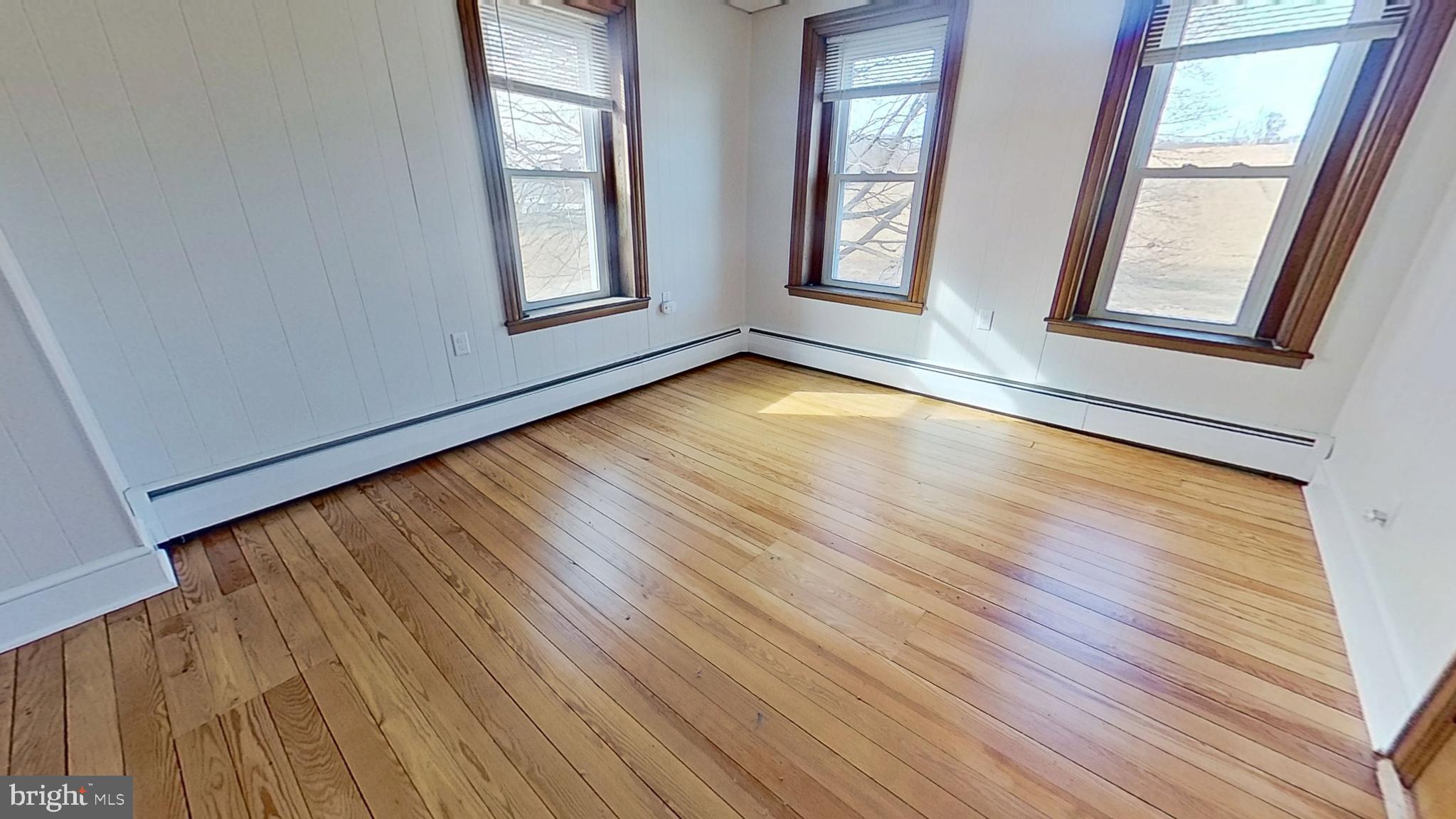 4676 Shaffers Church Road Glenville, PA 17329 - Photo 13 of 20 an empty room with wooden floor and windows