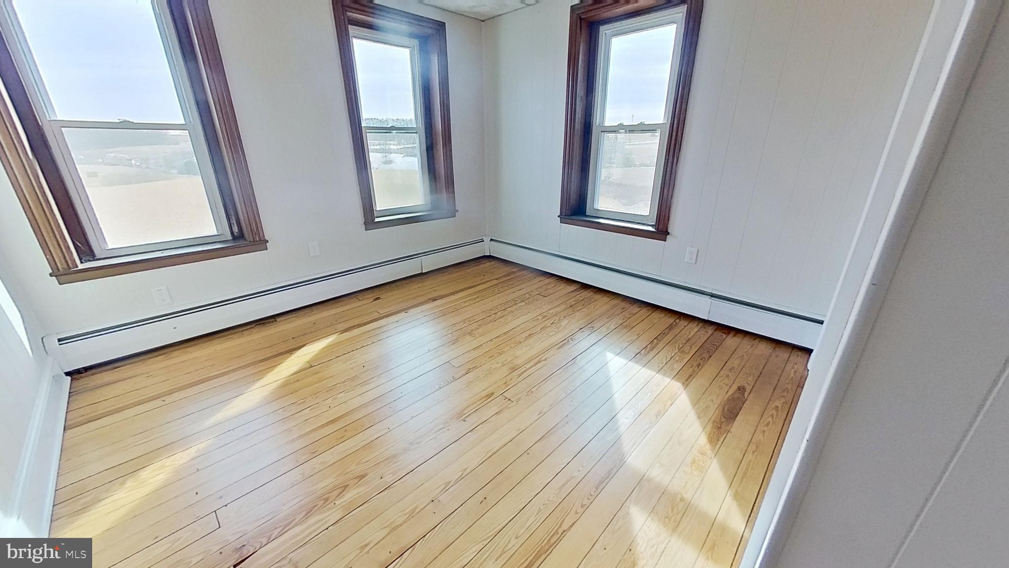 4676 Shaffers Church Road Glenville, PA 17329 - Photo 15 of 20 a view of an empty room with wooden floor and a window