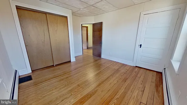 a view of hallway with wooden floor