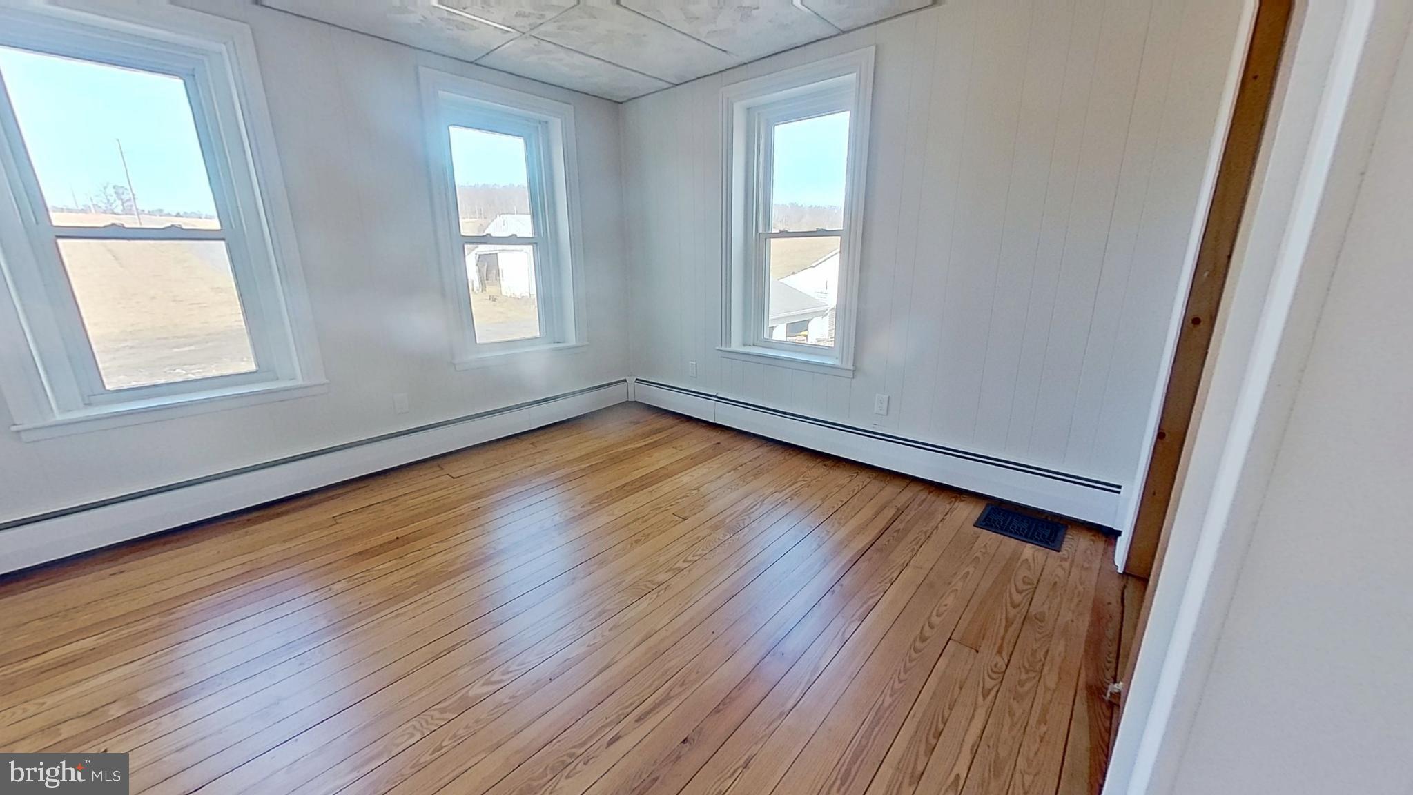 4676 Shaffers Church Road Glenville, PA 17329 - Photo 19 of 20 an empty room with wooden floor and windows