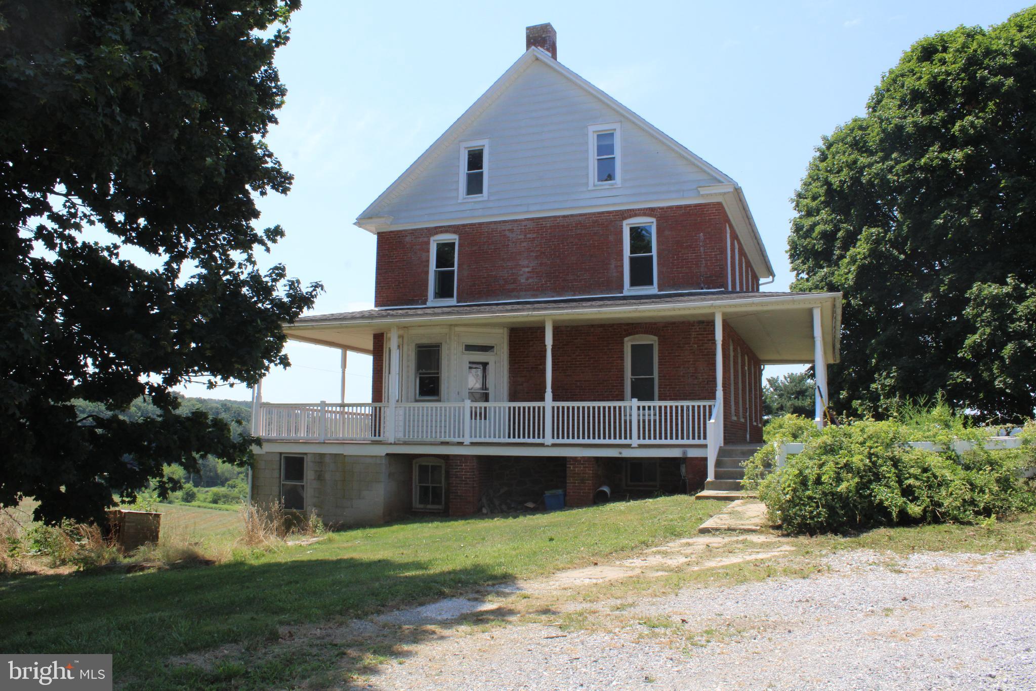 4676 Shaffers Church Road Glenville, PA 17329 - Photo 2 of 20 a front view of a house with a yard and garage