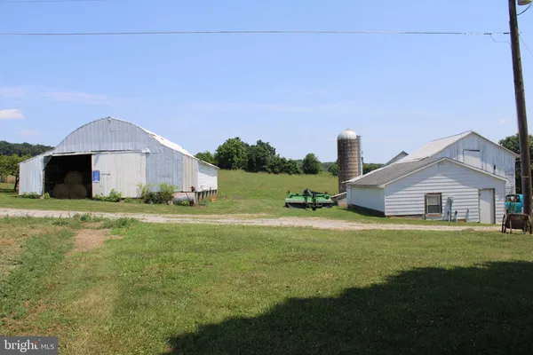a front view of a house with a garden and yard