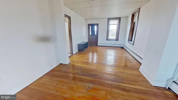 a view of an entryway with wooden floor