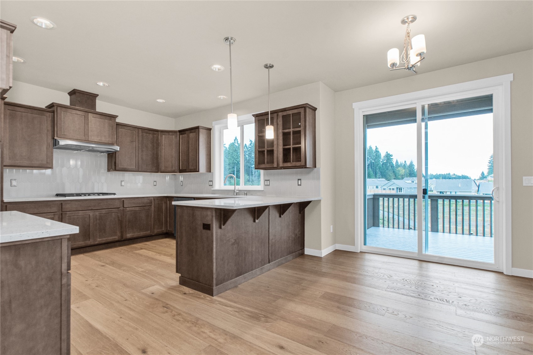 9741 7th Way Southeast Lacey, WA 98513 - Photo 19 of 40 a large kitchen with stainless steel appliances kitchen island granite countertop a sink and cabinets