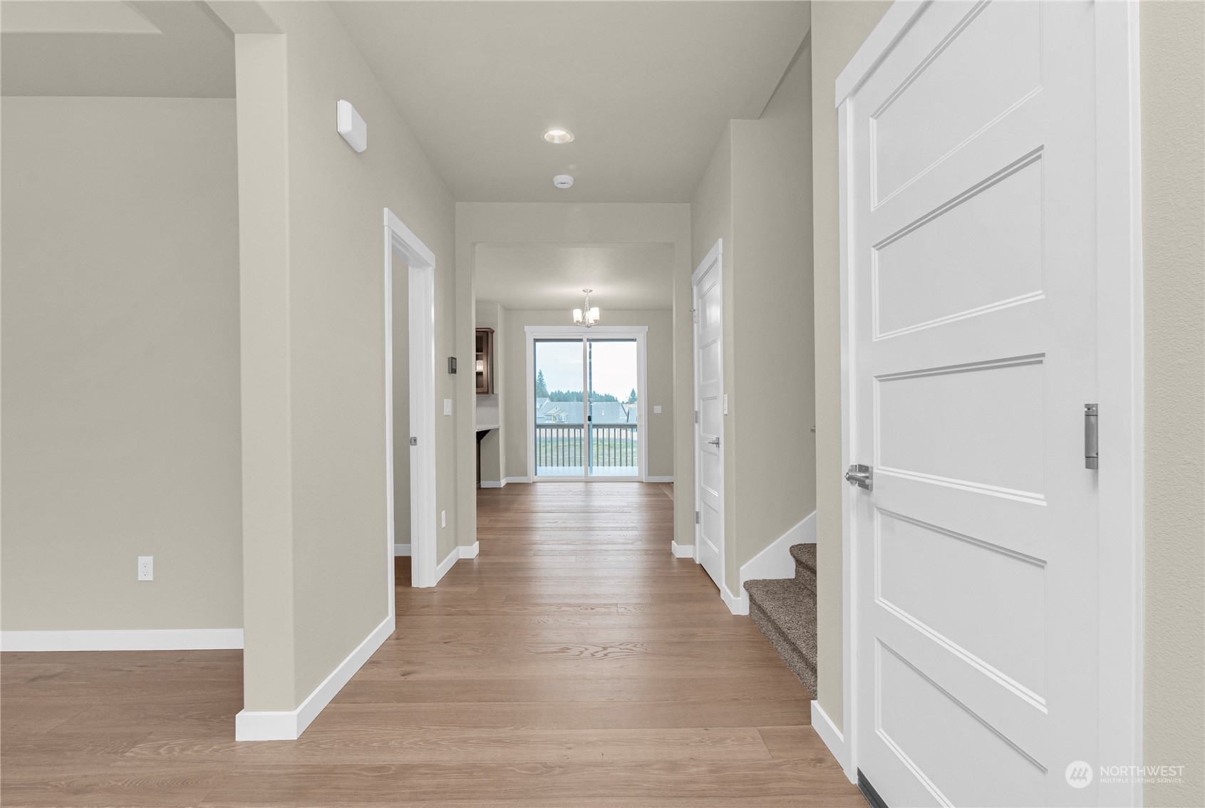 9741 7th Way Southeast Lacey, WA 98513 - Photo 5 of 40 a view of a hallway with wooden floor and a bathroom