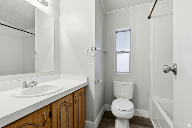 150 West 7500th South, Unit 55 Midvale, UT 84047 - Photo 18 of 28 Full bath featuring vanity, tub / shower combination, ornamental molding, and dark wood-style flooring