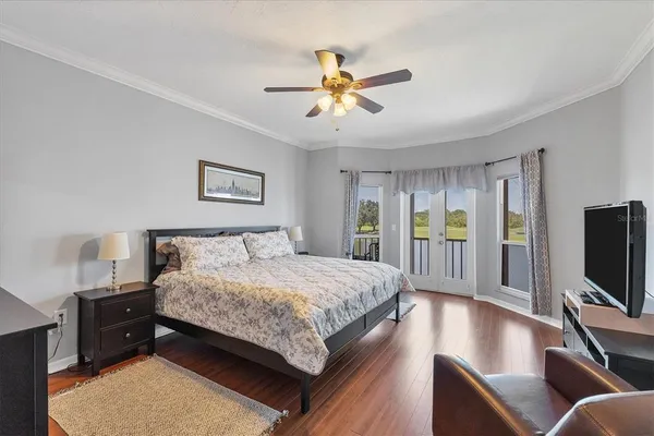 a bedroom with a bed and a flat screen tv