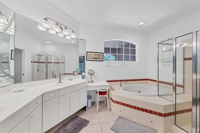 a spacious bathroom with a tub sink and mirror