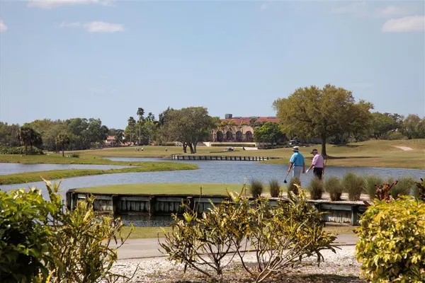 a view of a swimming pool with an outdoor seating and a yard