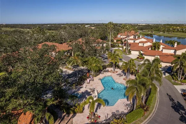 an aerial view of a house with a garden and lake view