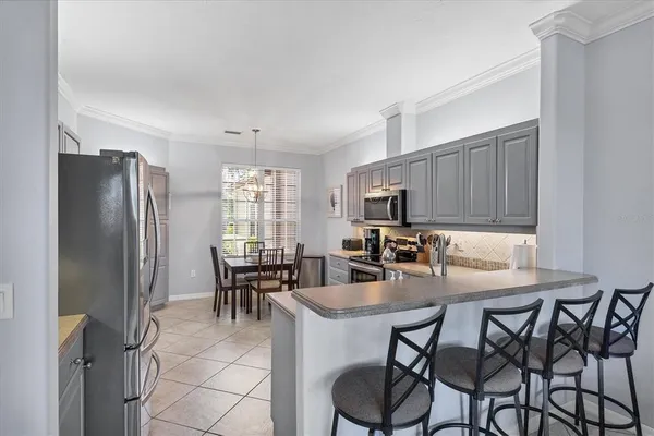 a kitchen with kitchen island a dining table and chairs