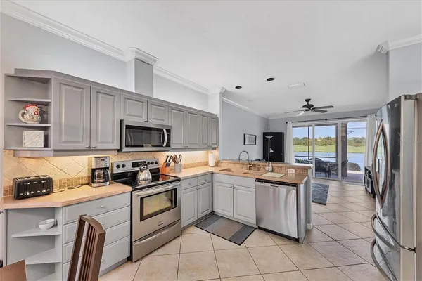 a kitchen with a sink a microwave and cabinets