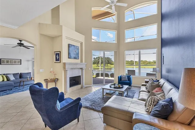a living room with furniture large window and fireplace