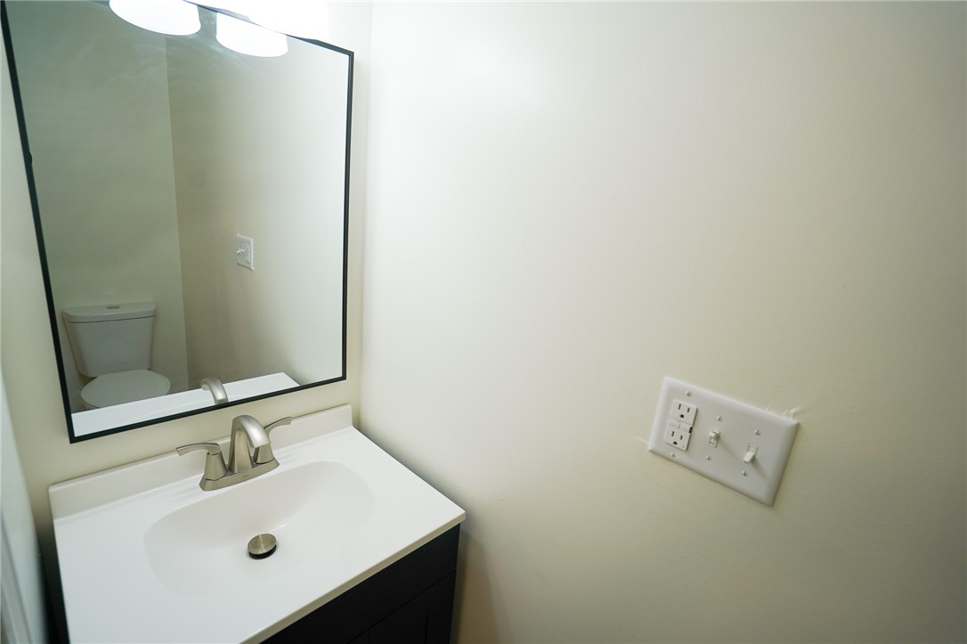 8746 Grubbs-Rex Road Arcanum, OH 45304 - Photo 18 of 38 This clean and bright bathroom features a vanity with a modern sink and a large???????????????????????? mirror.