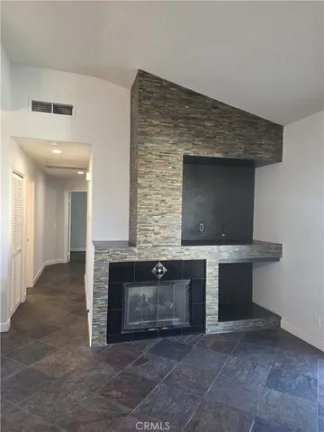 a view of room with kitchen island sink and fireplace