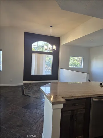 a view of a kitchen with granite countertop and sink