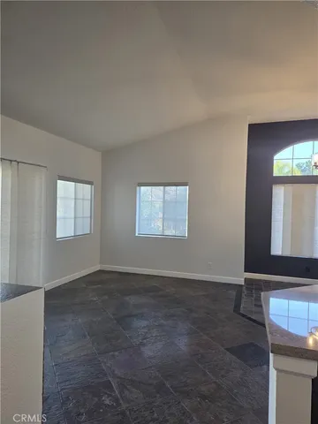 a view of a kitchen with furniture and a window