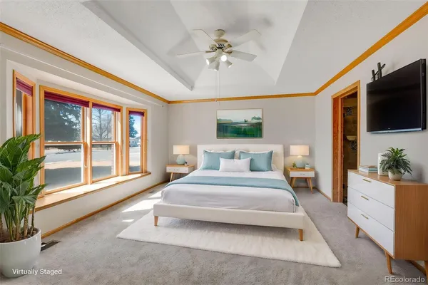 a spacious bedroom with a large bed and a large window