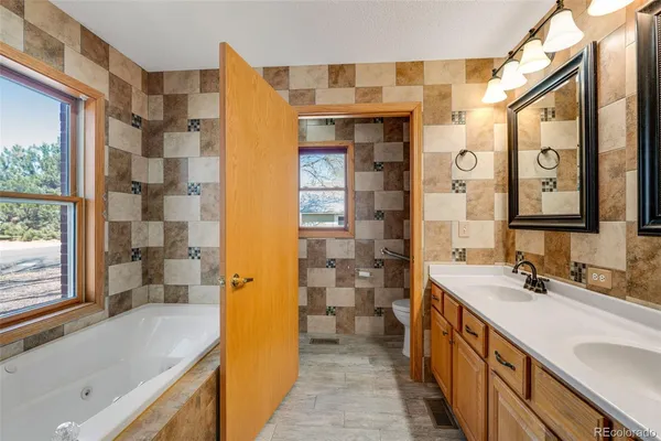 a bathroom with a double vanity sink and a bathtub