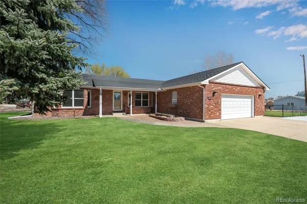 a front view of a house with a garden and porch