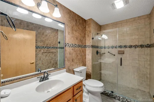 a bathroom with a sink toilet and shower