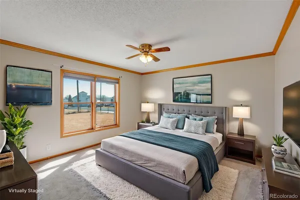 a bedroom with a large bed and a chandelier