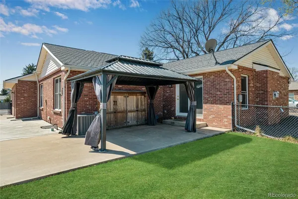 a view of a house with a yard and deck
