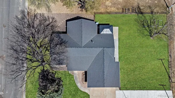 an aerial view of a house with a garden and trees