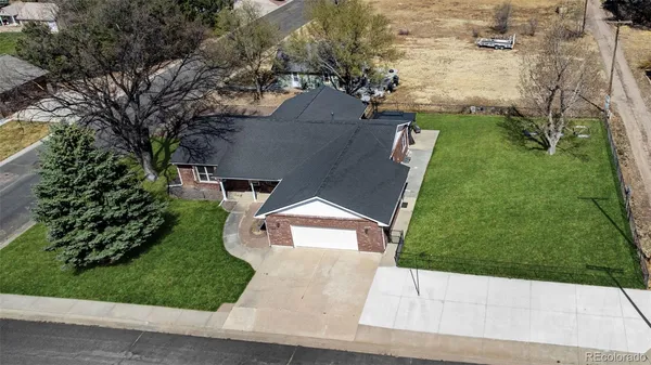 an aerial view of a house with a yard