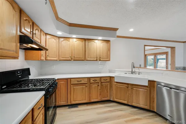 a kitchen with a sink stove and cabinets