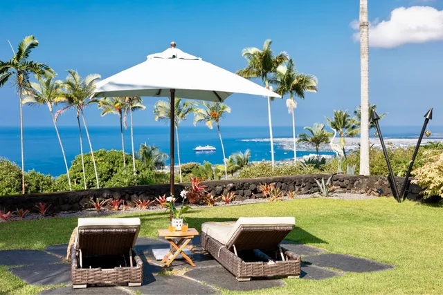 a view of a chairs and table in backyard of house
