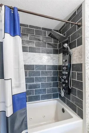 a bathroom with a bathtub and shower