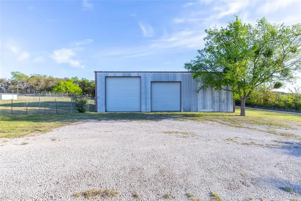a view of a yard with large trees