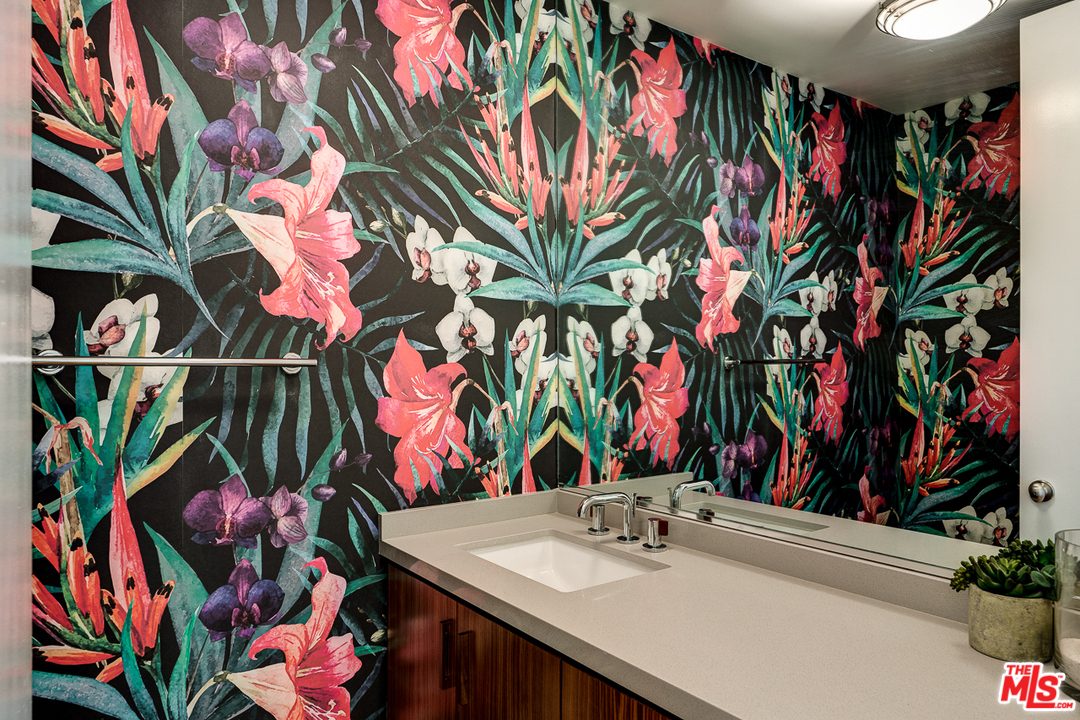 1490 El Mirador Drive Pasadena, CA 91103 - Photo 12 of 52 a bathroom with a sink a mirror and shower curtain