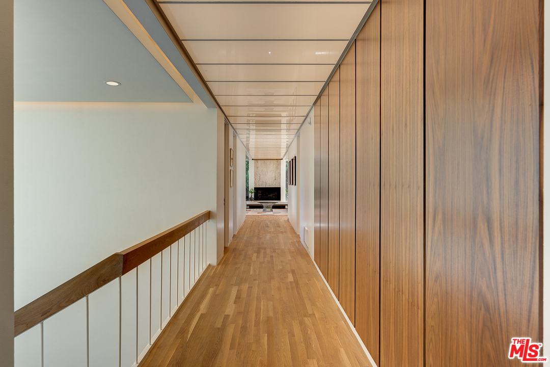 1490 El Mirador Drive Pasadena, CA 91103 - Photo 18 of 52 a view of a hallway with wooden floor and staircase