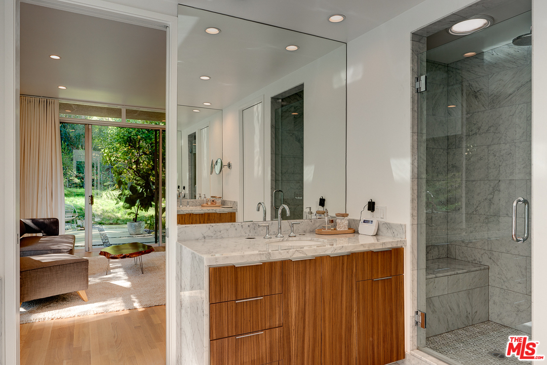 1490 El Mirador Drive Pasadena, CA 91103 - Photo 22 of 52 a bathroom with a granite countertop sink mirror and shower