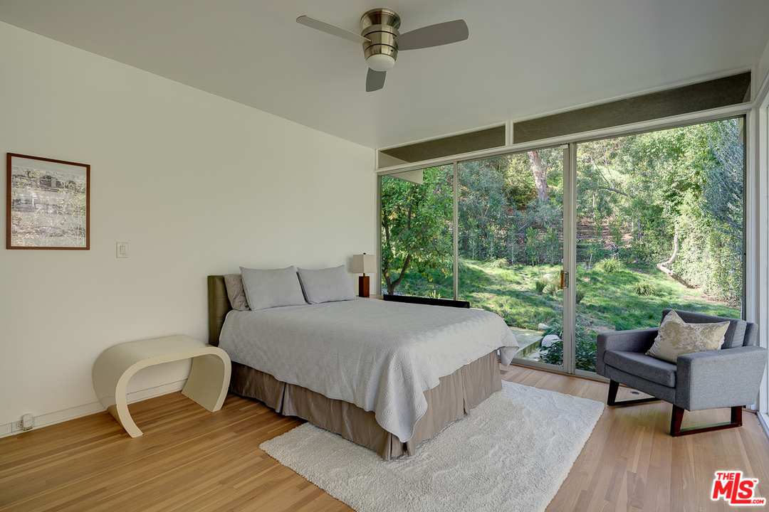 1490 El Mirador Drive Pasadena, CA 91103 - Photo 26 of 52 a bedroom with a bed and large windows