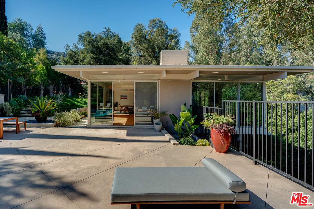 1490 El Mirador Drive Pasadena, CA 91103 - Photo 35 of 52 a view of a patio with table and chairs potted plants and floor to ceiling window