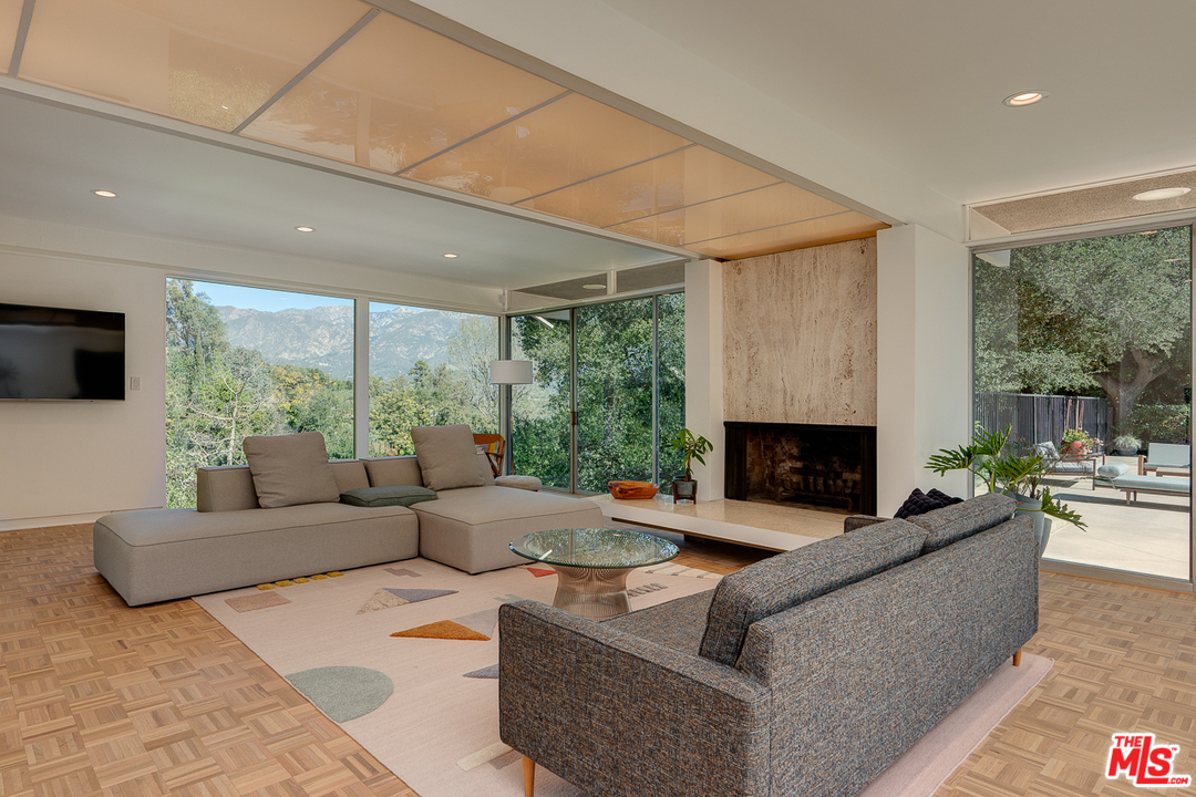 1490 El Mirador Drive Pasadena, CA 91103 - Photo 8 of 52 a living room with fireplace furniture and a large window