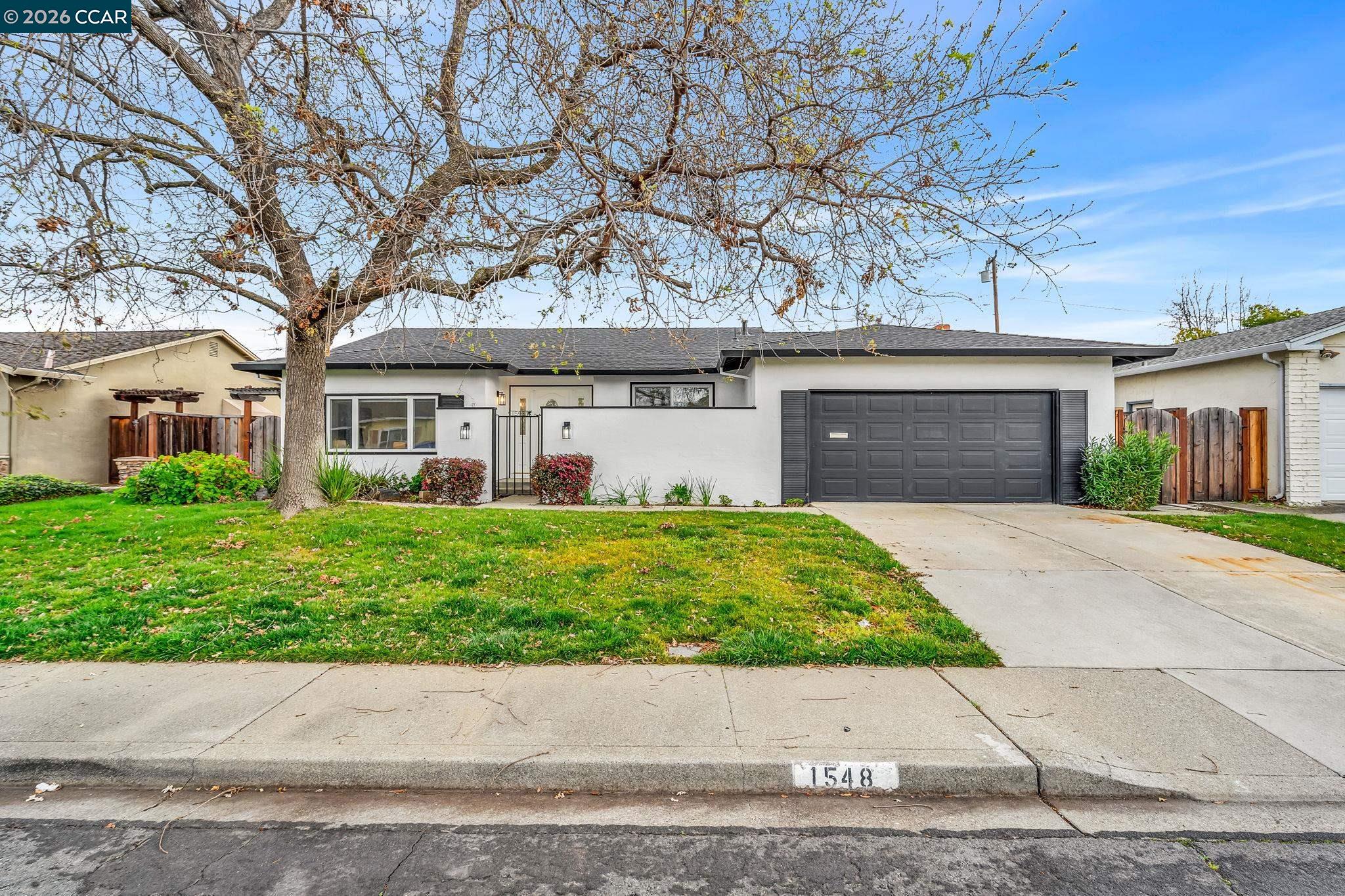 1548 Dianda Drive Concord, CA 94521 - Photo 2 of 59 front view of a house with a yard and potted plants