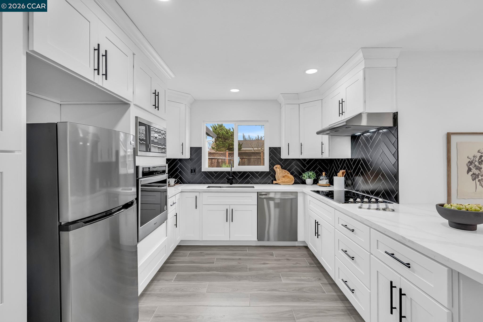 1548 Dianda Drive Concord, CA 94521 - Photo 21 of 59 a kitchen with stainless steel appliances granite countertop a refrigerator sink and cabinets