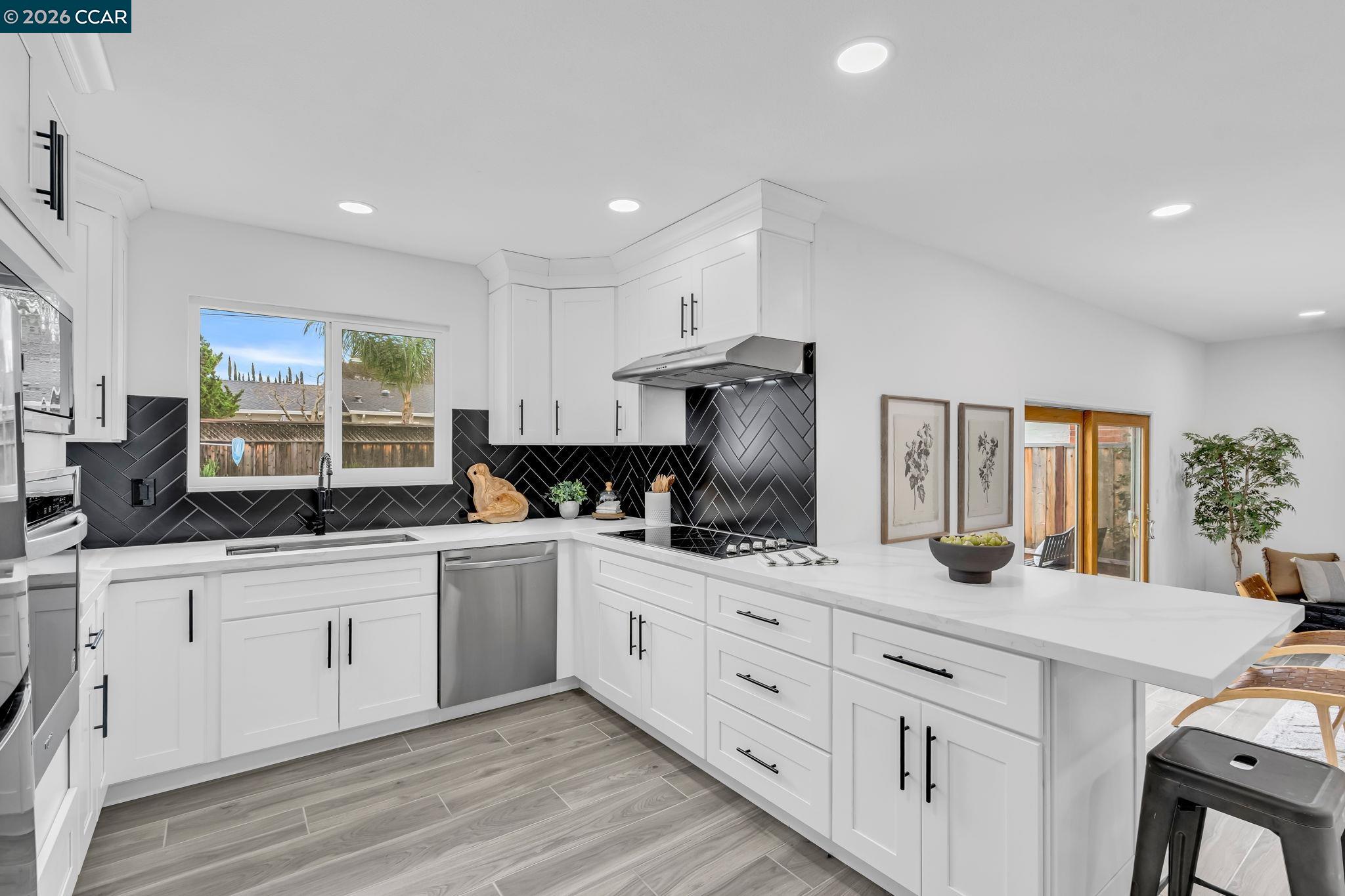 1548 Dianda Drive Concord, CA 94521 - Photo 22 of 59 a kitchen with granite countertop a sink stainless steel appliances and white cabinets