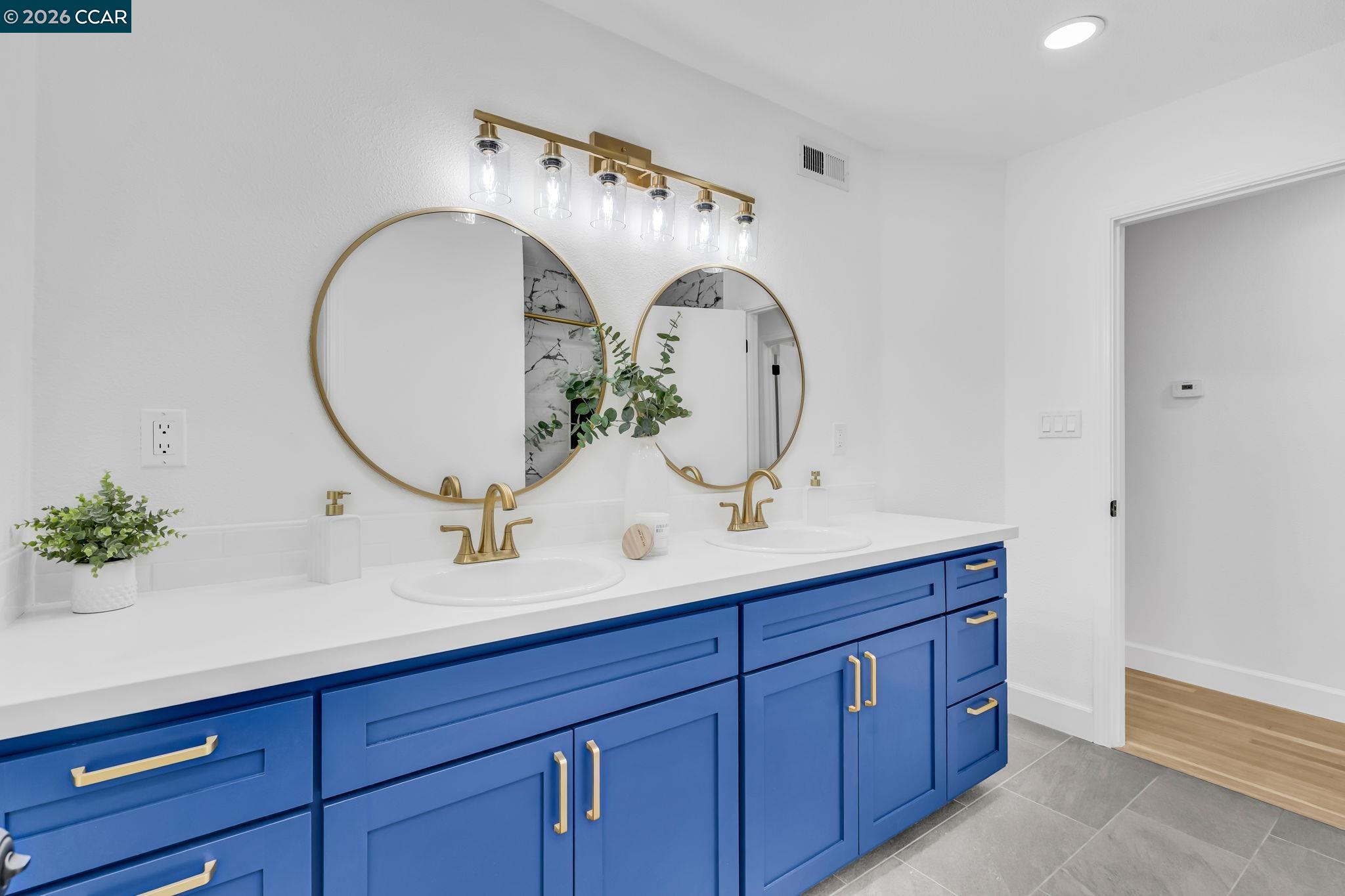 1548 Dianda Drive Concord, CA 94521 - Photo 32 of 59 a bathroom with a double vanity sink and a mirror