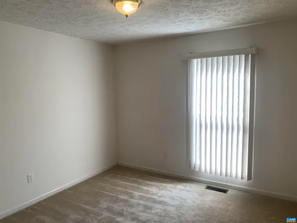 an empty room with a wooden door