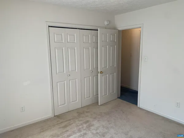 a backyard of a house with large trees