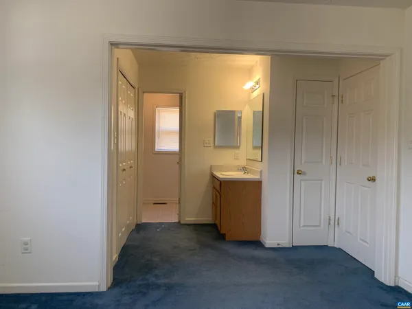 a view of a bathroom with sink and mirror