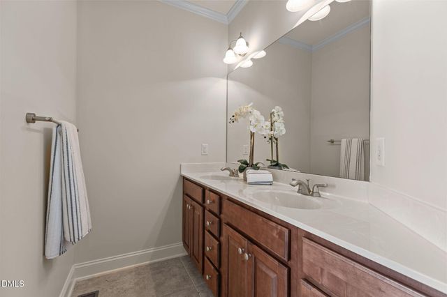 a bathroom with a sink a light fixture and a mirror