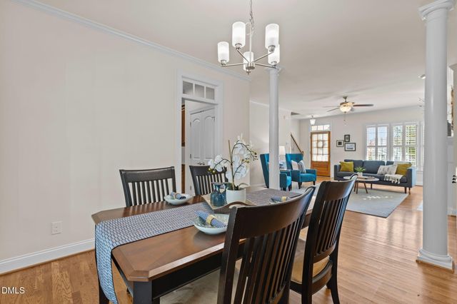 a view of a dining room with furniture wooden floor and chandelier